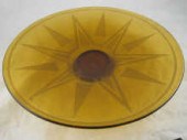 An amber glass dish with etche