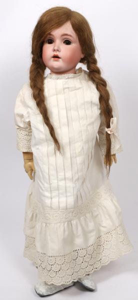 AN ANTIQUE 31 INCH BISQUE HEAD DOLL