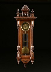 AN ANTIQUE BRASS AND CARVED WA