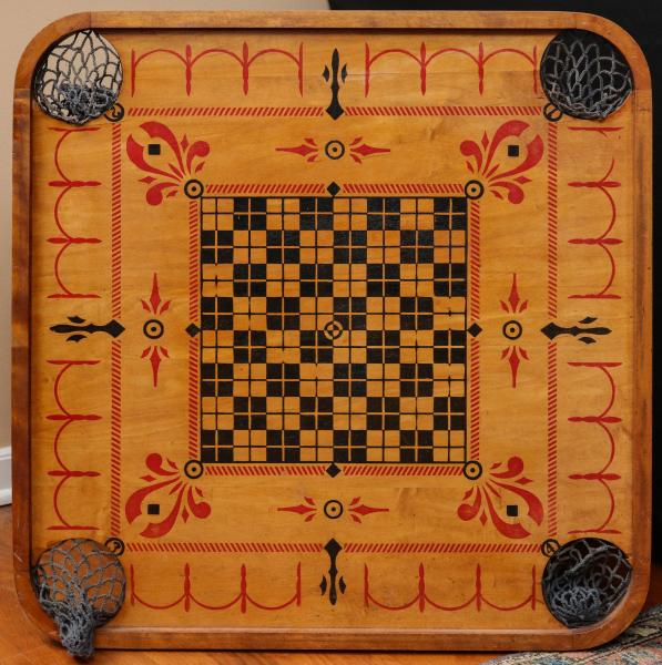 AN ANTIQUE CARROM BOARD CIRCA