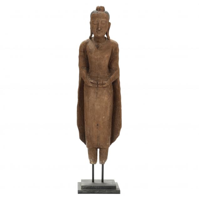 AN ANTIQUE CARVED WOODEN STANDING