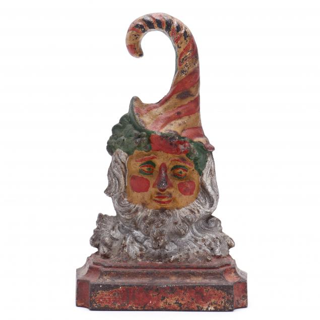 AN ANTIQUE CAST IRON JESTER
