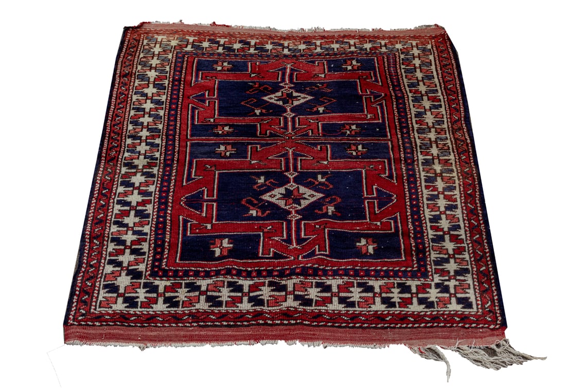 AN ANTIQUE CAUCASIAN CARPETAn