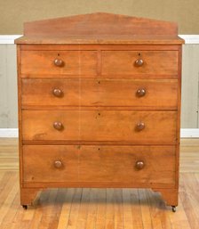 An antique cherry chest with a