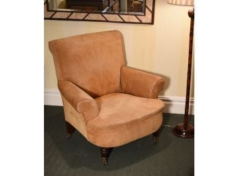 An antique club chair upholstered