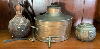 An antique copper samovar/covered