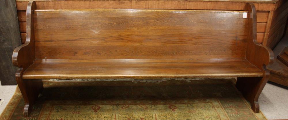 AN ANTIQUE OAK CHURCH BENCH,