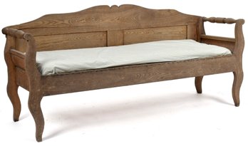 An antique oak hall bench with a
