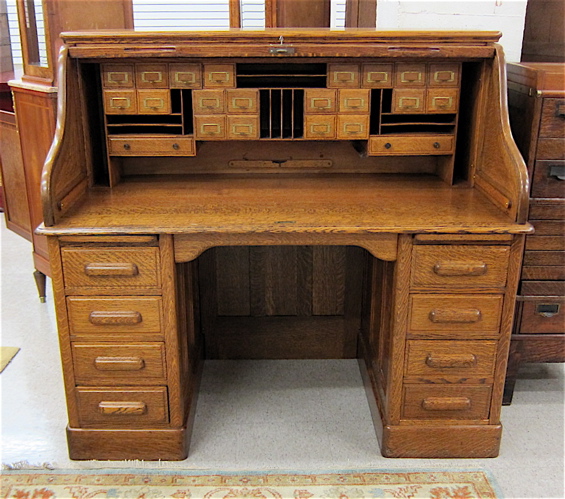 AN ANTIQUE OAK ROLL-TOP DESK