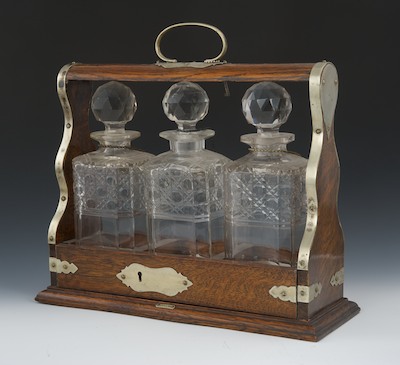 An Antique Oak Tantalus Three cut