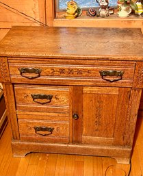 An antique oak wash stand with a