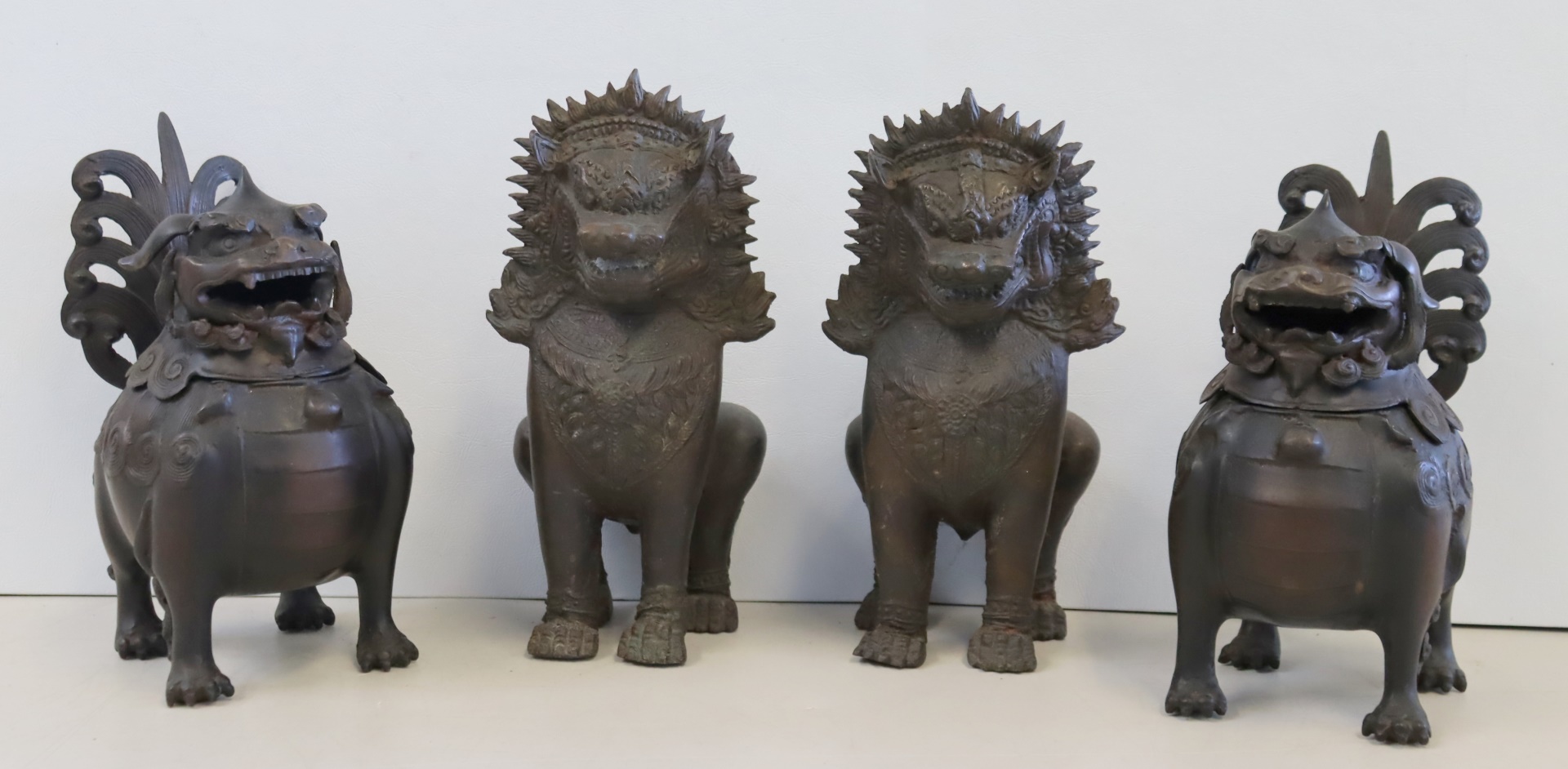 AN ANTIQUE PAIR OF BRONZE FOO LIONS
