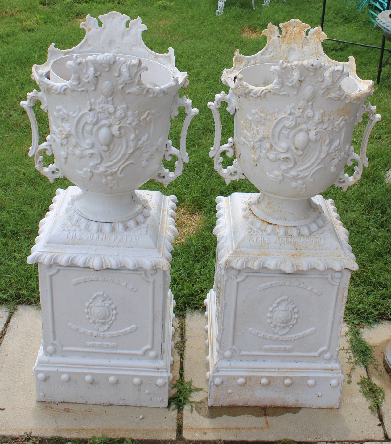 AN ANTIQUE PAIR OF CAST IRON URNS