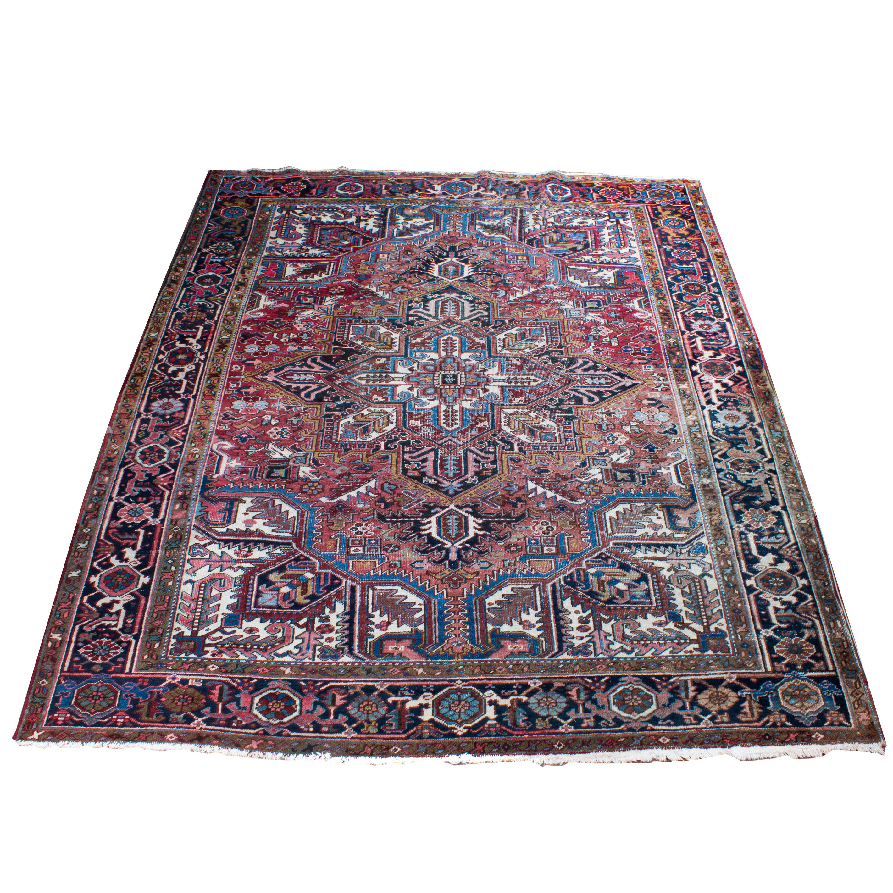 AN ANTIQUE PERSIAN HERIZ CARPET