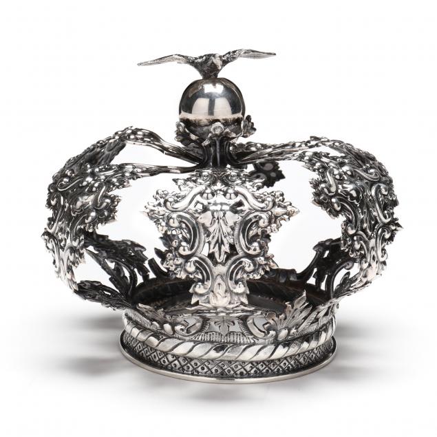 AN ANTIQUE SILVER SANTOS FIGURE