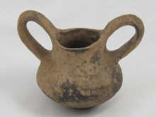 An antique squat turned pot with