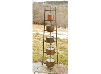 An antique tapered iron pot rack