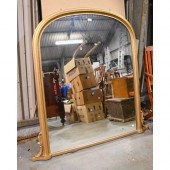 An arched gold painted wood ov
