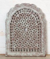 AN ARCHED PIERCED TINTED TERRA