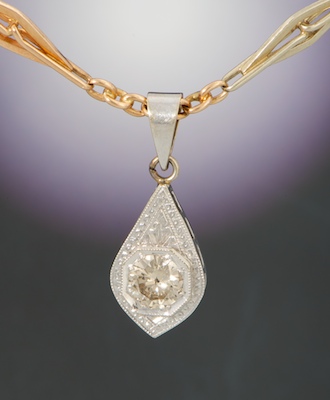 An Art Deco Diamond Pendant on