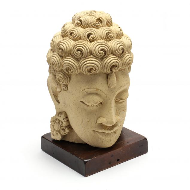 AN ASIAN CARVED STONE BUDDHA