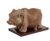AN ASIAN EARTHENWARE PIGGY BAN