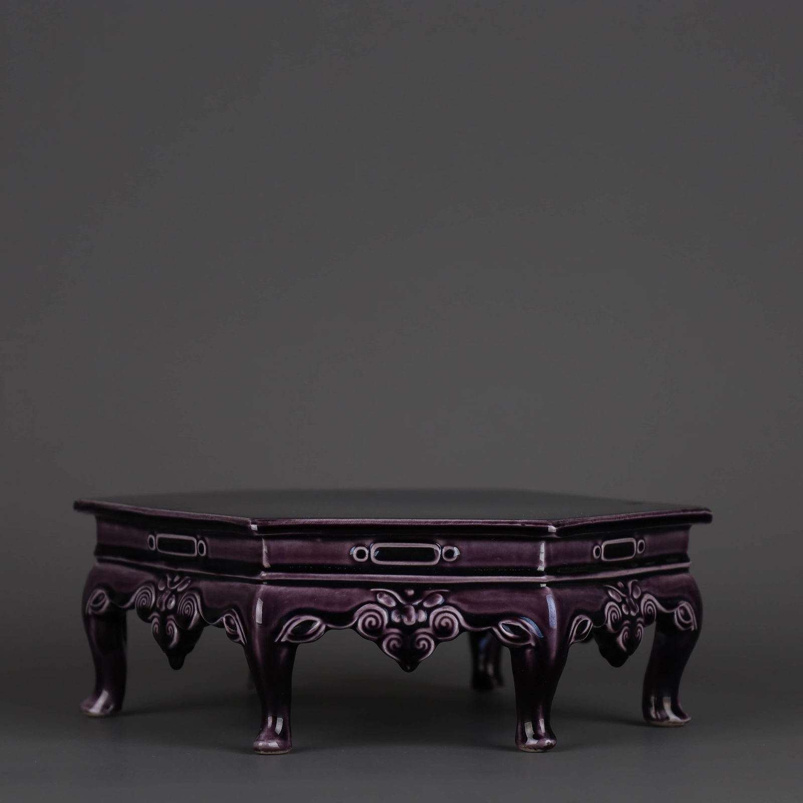 AN AUBERGINE-GLAZED CARVED