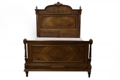 An early 20th Century walnut bed,