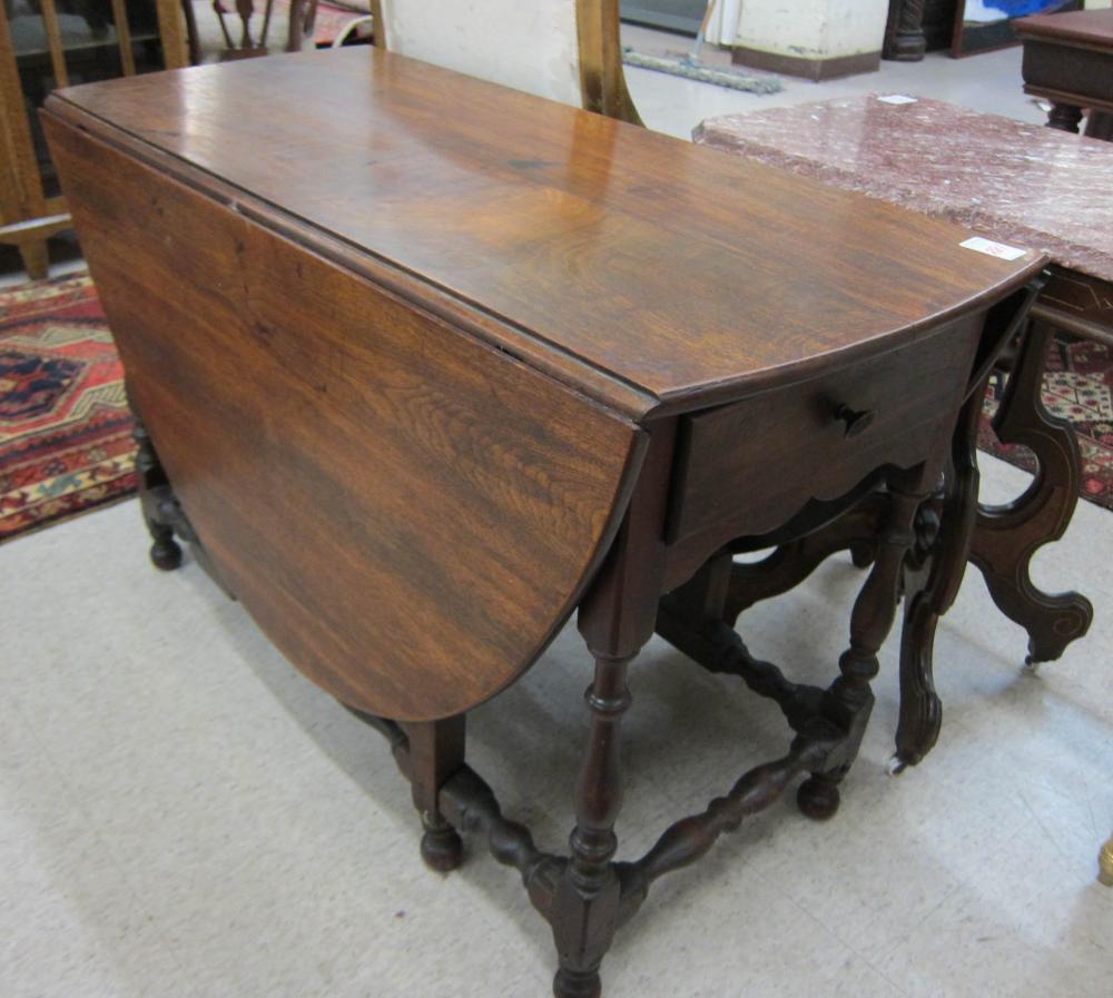 AN EARLY DROP-LEAF WALNUT DINING