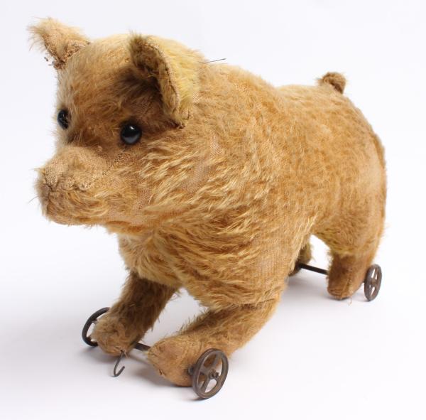 AN EARLY GOLD MOHAIR BEAR ON IRON