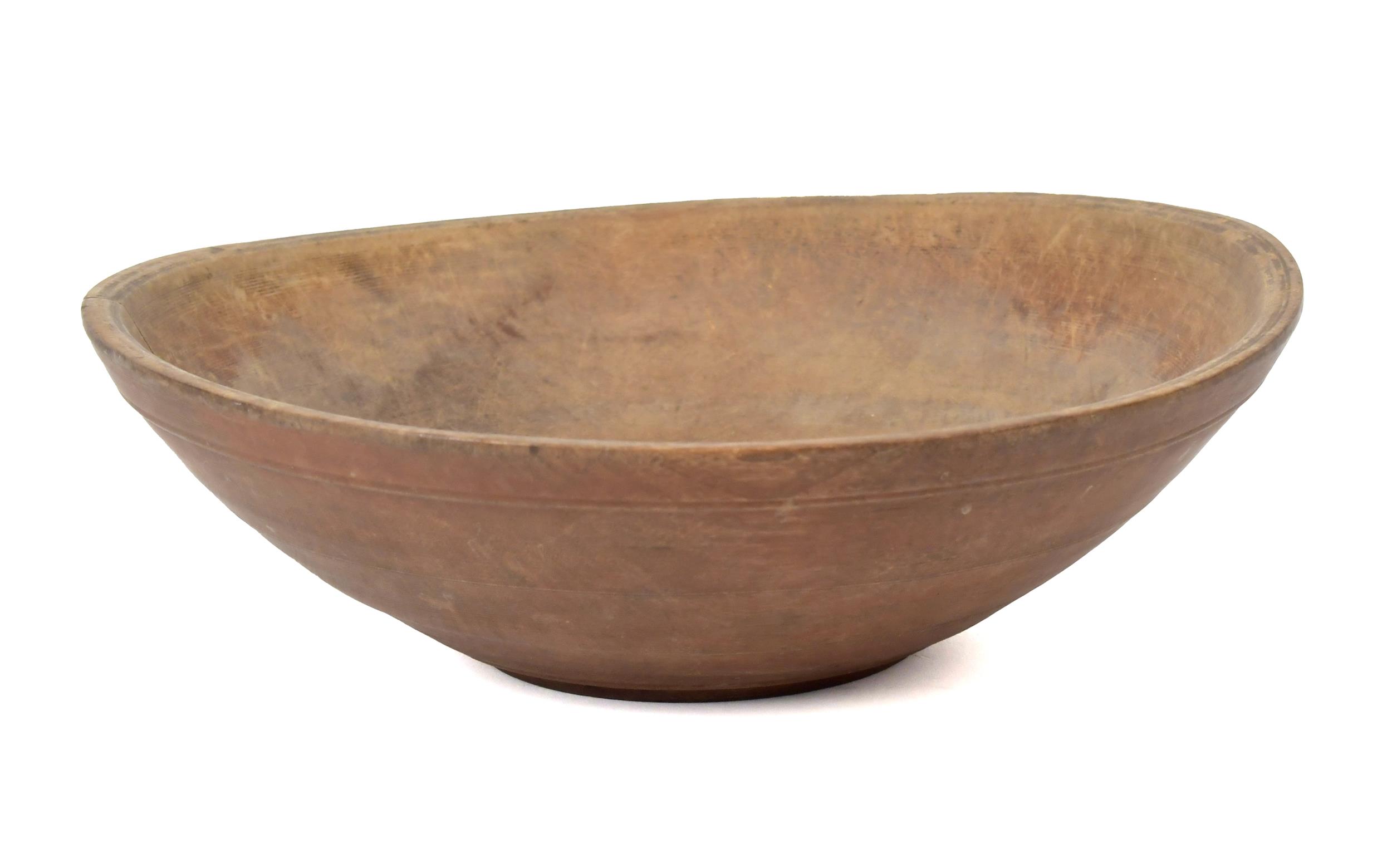 AN EARLY RED PAINTED TREENWARE