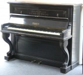 An ebonised upright piano by C