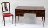 An Edwardian mahogany desk fit