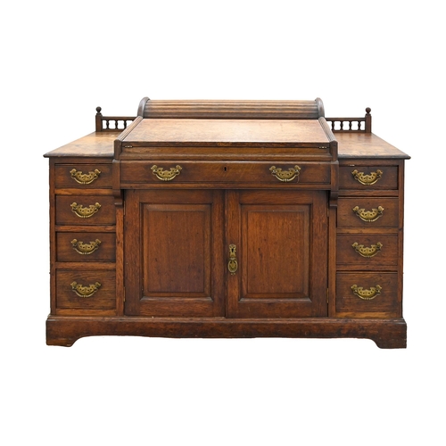 An Edwardian oak desk, with four