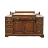 An Edwardian oak desk, with fo
