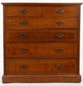 An Edwardian walnut chest of t