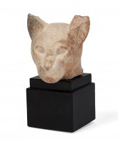 AN EGYPTIAN LIMESTONE HEAD OF