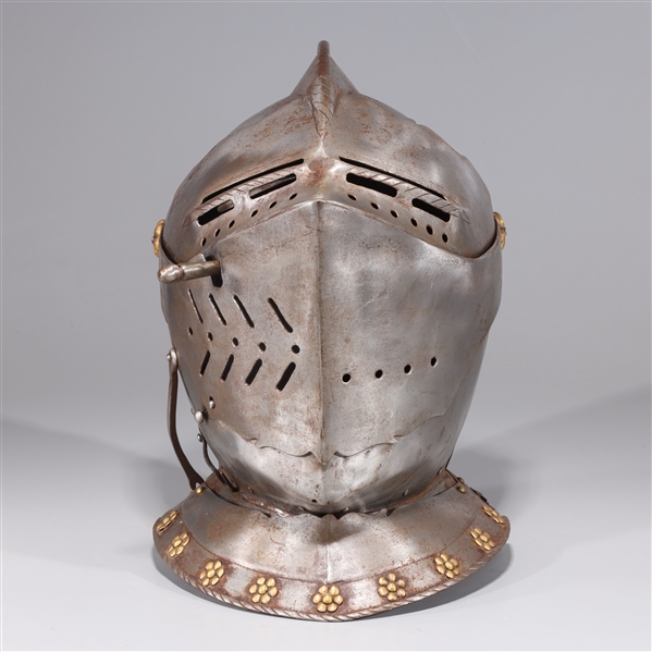An elaborately pierced close helm