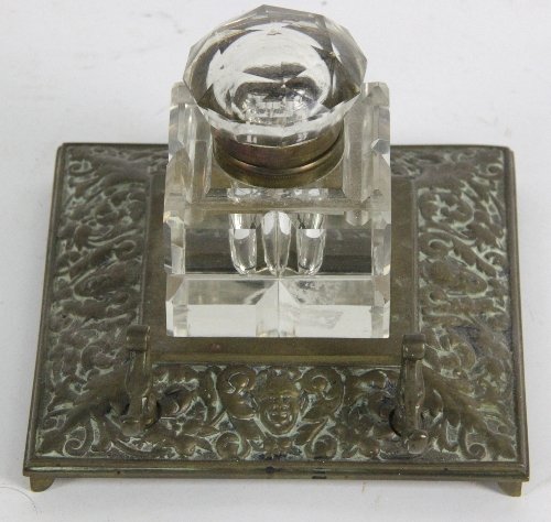An embossed brass inkstand fitted a