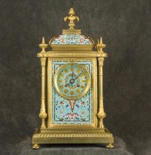 AN ENAMELED BRASS MANTEL CLOCK