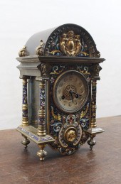 AN ENAMELED BRASS MANTEL CLOCK