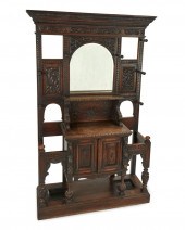 AN ENGLISH CARVED OAK HALL TRE