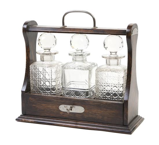 An English Oak Tantalus set with