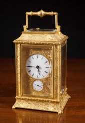 AN ENGRAVED BRASS REPEATER CAR