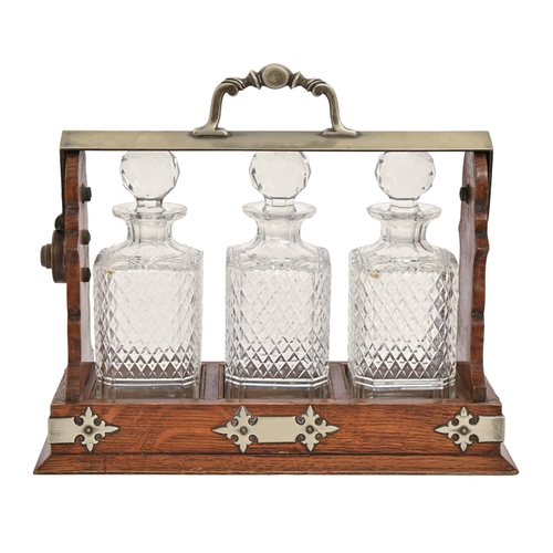 An EPNS mounted oak tantalus and