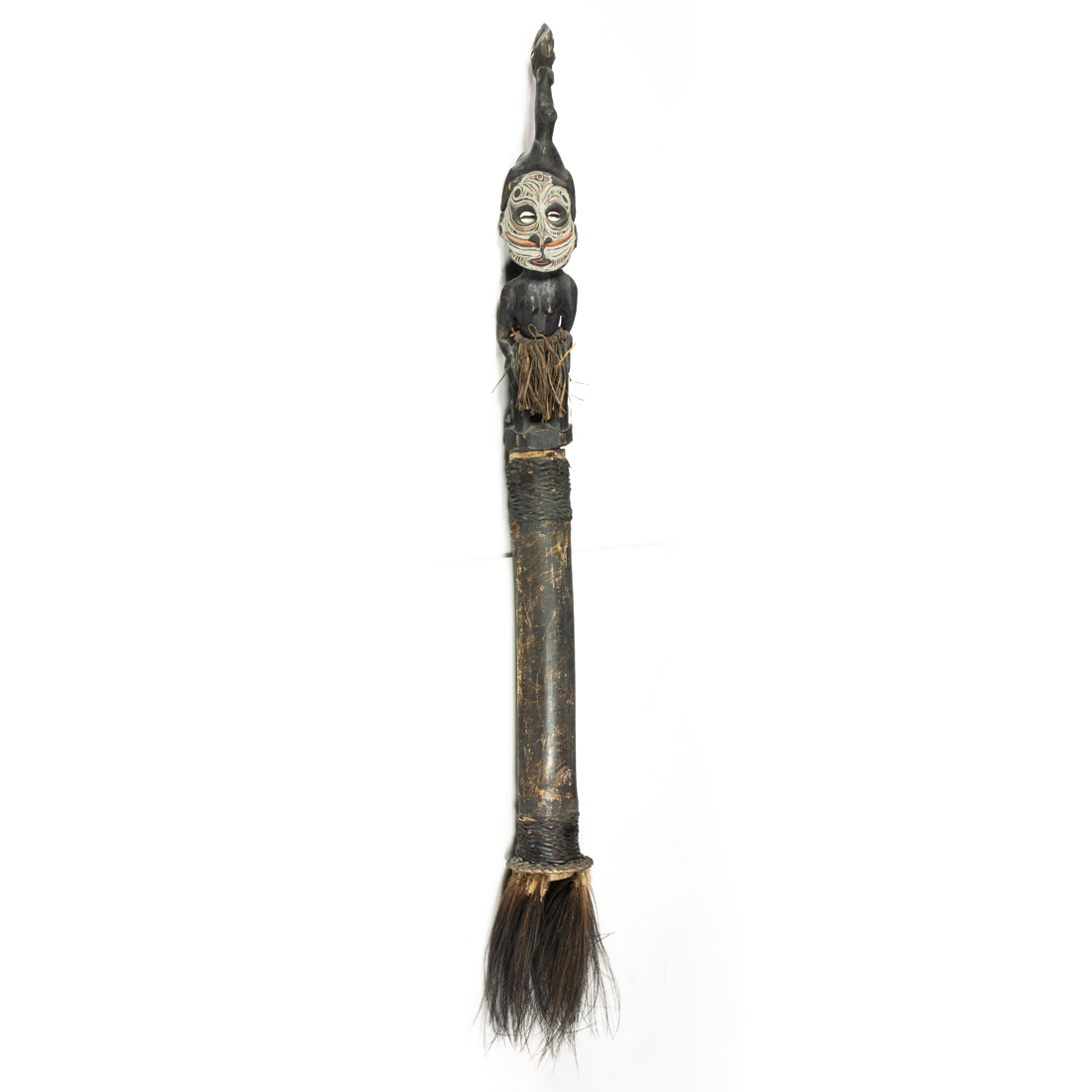 AN ETHNIC FIGURAL STAFF CARVED AS A