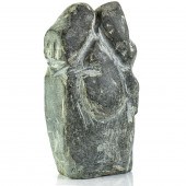 AN INUIT BASALT FIGURE OF A MO