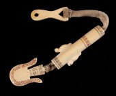 AN INUIT CARVED SEWING KITAN I