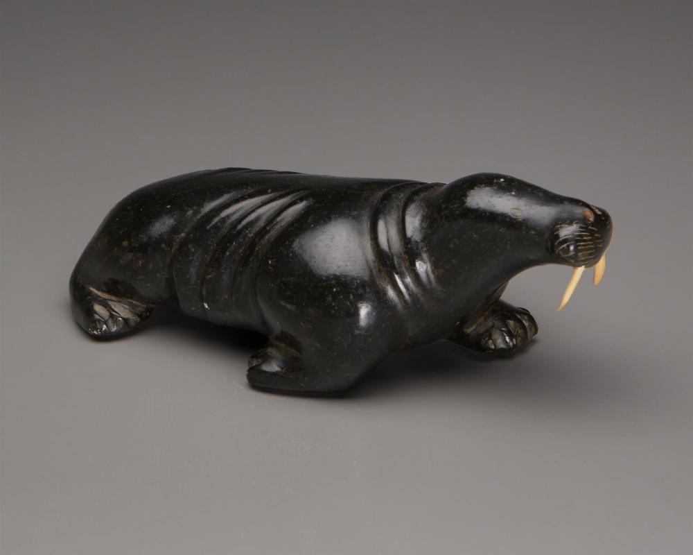AN INUIT CARVED STEATITE WALRUS, BY