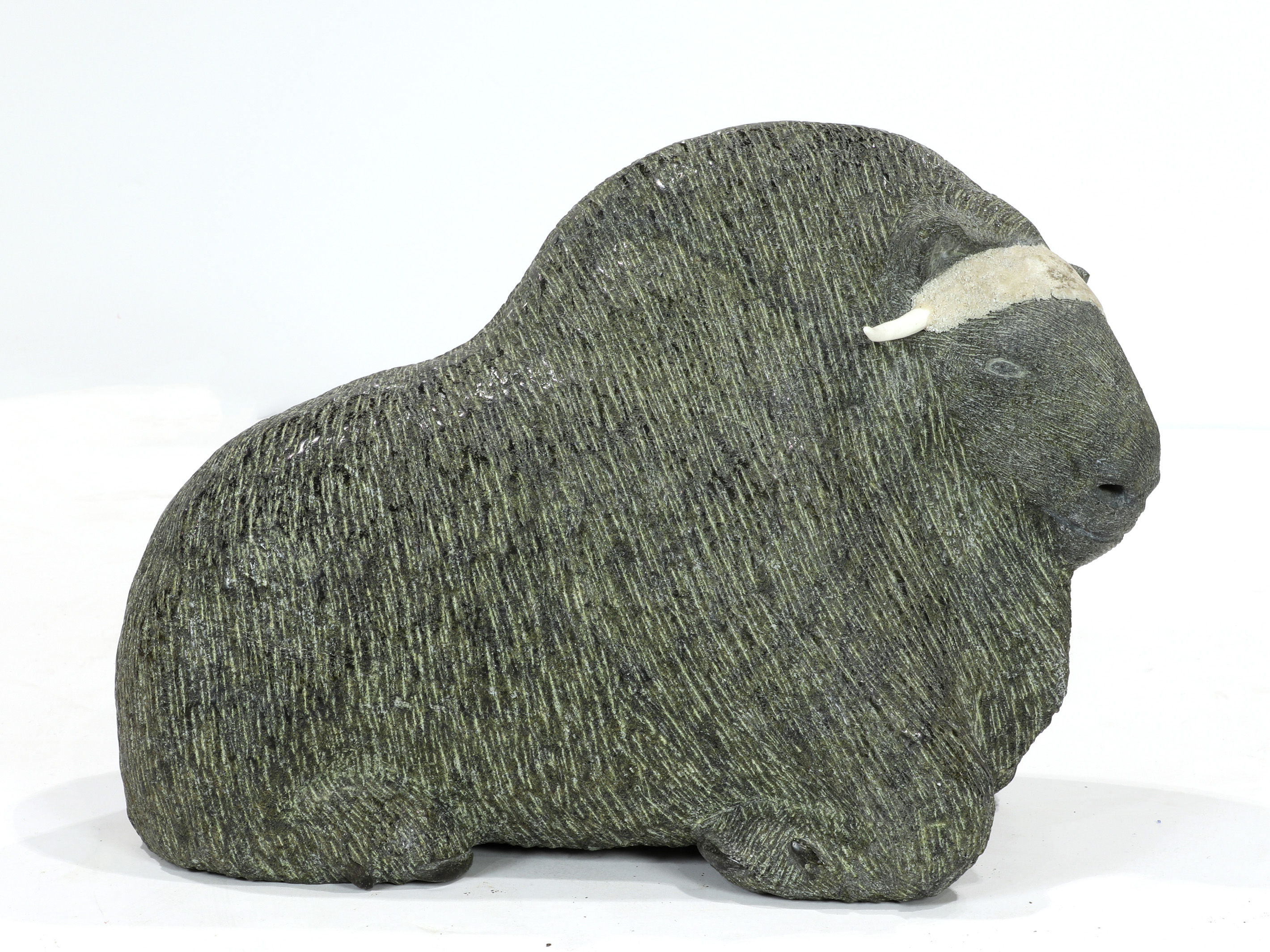 AN INUIT SOAPSTONE CARVING OF A